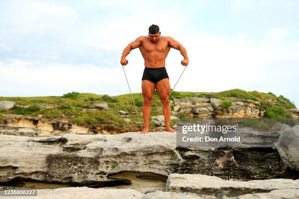 Chris Kavvalos does some resistance exercises with a rope during an early morning photo shoot at Little Bay on May 31, 2020 in Sydney, Australia....