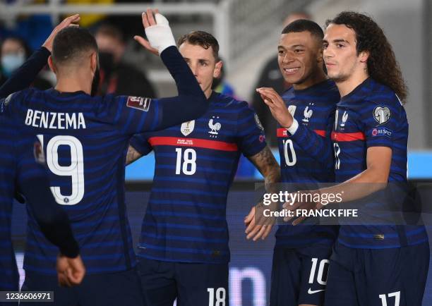 France's forward Kylian Mbappe celebrates with teammates scoring during the FIFA World Cup Qatar 2022 qualification Group D football match between...