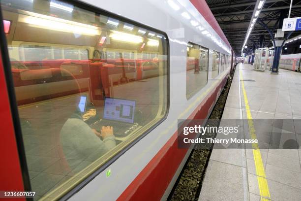 Passengers are looking at there computers while waiting for the departure of a Thalys from 'Brussels-South railway station' to Paris Nord on November...