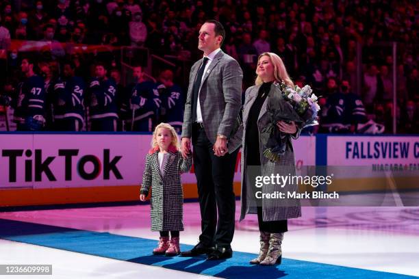 Former Toronto Maple Leafs captain Dion Phaneuf, joined by his daughter Zaphire and wife Elisha Cuthbert, stand during the Canadian national anthem...