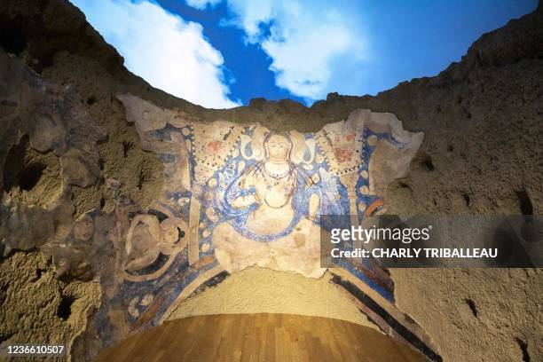 This photo taken on October 7, 2021 shows a replica of a cave painting of a blue Bodhisattva, part of artefacts destroyed by the Taliban in 2001,...