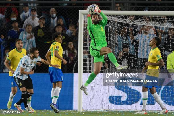 Brazil's goalkeeper Alisson catches the ball during the South American qualification football match for the FIFA World Cup Qatar 2022 against...