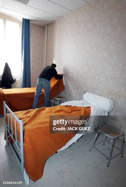 Homeless person, member of "Les Enfants de Don Quichotte" and coming for the Canal Saint-Martin, makes his bed in a bedroom of the Nogent stronghold,...