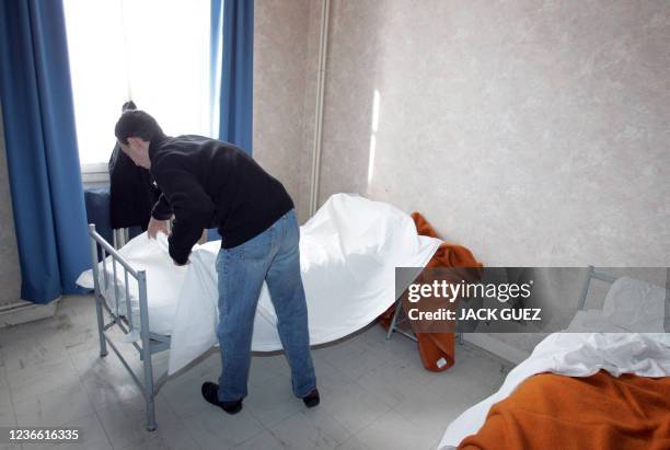 Homeless person, member of "Les Enfants de Don Quichotte" and coming for the Canal Saint-Martin, makes his bed in a bedroom of the Nogent stronghold,...
