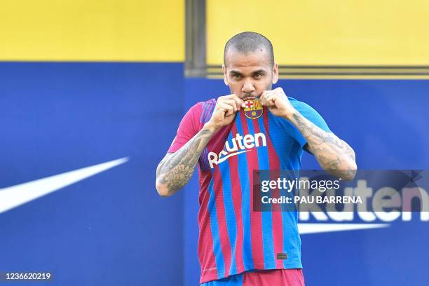 New FC Barcelona's Brazilian defender Dani Alves kisses his jersey during the presentation ceremony at the Camp Nou stadium in Barcelona on November...