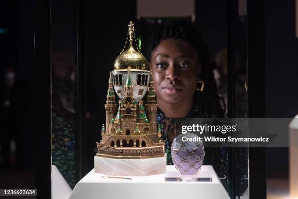 Staff member looks at the Moscow Kremlin Egg the largest Imperial Egg inspired by the architecture of the Dormition Cathedral, on loan from the...