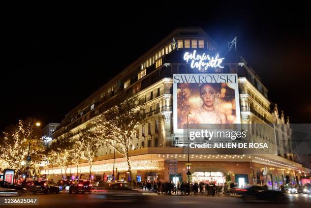 This photograph taken on November 17, 2021 shows an exterior view of the Galeries Lafayette building during the Christmas windows opening night at...