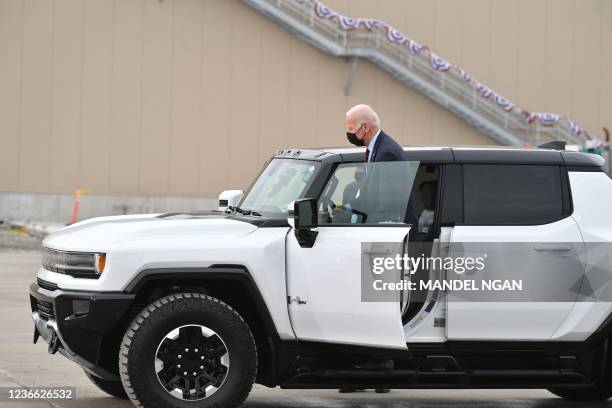 President Joe Biden climbs into an electric hummer as he tours the General Motors Factory ZERO electric vehicle assembly plant in Detroit, Michigan...