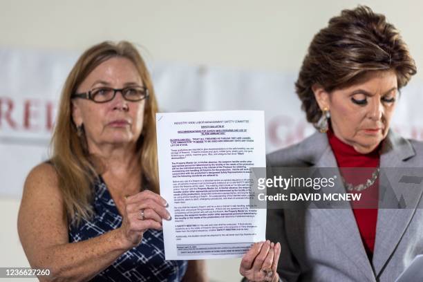 Mamie Mitchell , script supervisor on the film "Rust", and attorney Gloria Allred hold a copy of safety recommendations for the use of live...