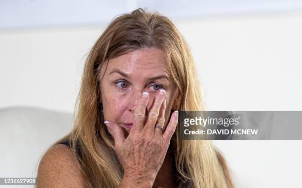 Mamie Mitchell, script supervisor on the film "Rust", touches her face during a press conference with her attorney, Gloria Allred, after filing a...