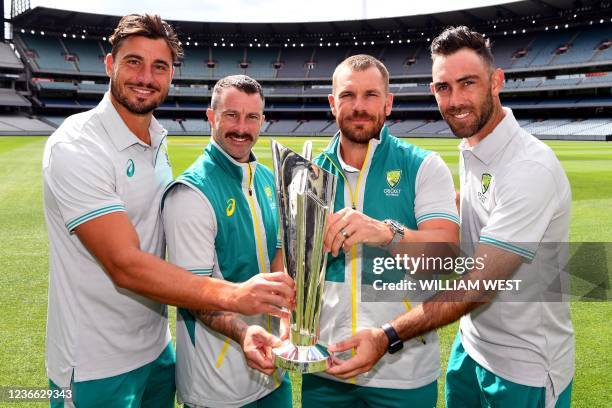 Australia's Marcus Stoinis, Matthew Wade, Aaron Finch and Glenn Maxwell pose with the Twenty20 World Cup trophy upon their return to Melbourne on...