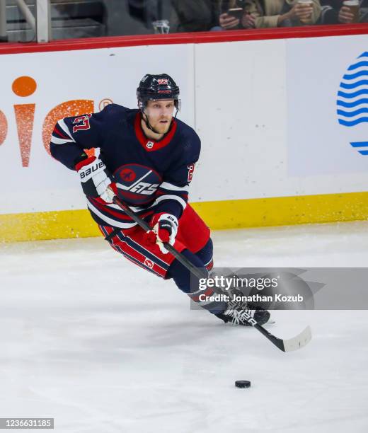 Nikolaj Ehlers of the Winnipeg Jets plays the puck during second period action against the San Jose Sharks at Canada Life Centre on November 11, 2021...