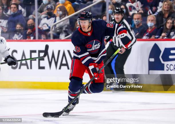 Riley Nash of the Winnipeg Jets plays the puck during first period action against the San Jose Sharks at Canada Life Centre on November 11, 2021 in...