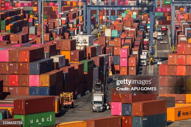 Shipping containers and trucks are seen inside the Port of Los Angeles in San Pedro, California, November 17, 2021. This morning the Governor of...