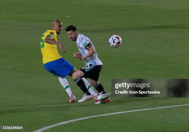 Messi of Argentina fights for the ball with Fabinho of Brazil during a match between Argentina and Brazil as part of South American Qualifiers for...