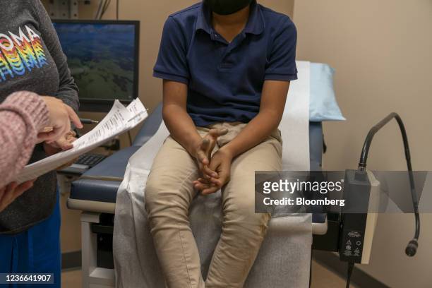 Child waits to receive a dose of a Covid-19 vaccine at an Oklahoma County Health Department Vaccine Clinic in Oklahoma City, Oklahoma, U.S., on...
