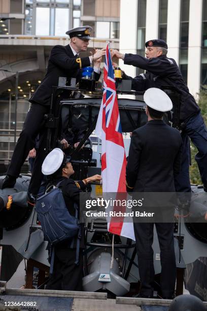 Royal Navy Reservists fix a White Ensign flag to a ribbed boat before the Lord Mayor's Show in the City of London, the capital's financial and...