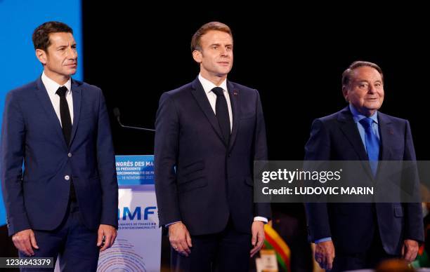 Newly elected President of "France's Mayors' Association" and Cannes' mayor David Lisnard , French President Emmanuel Macron and AMF Vice-President...