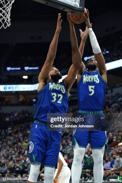 Malik Beasley; and Karl-Anthony Towns of the Minnesota Timberwolves grabs the rebound against the Phoenix Suns on November 15, 2021 at Target Center...