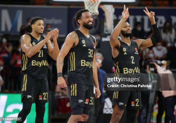 Darrun Hilliard of FC Bayern Munich celebrates with Corey Walden of FC Bayern Munich and Augustine Rubit of FC Bayern Munich during the Turkish...