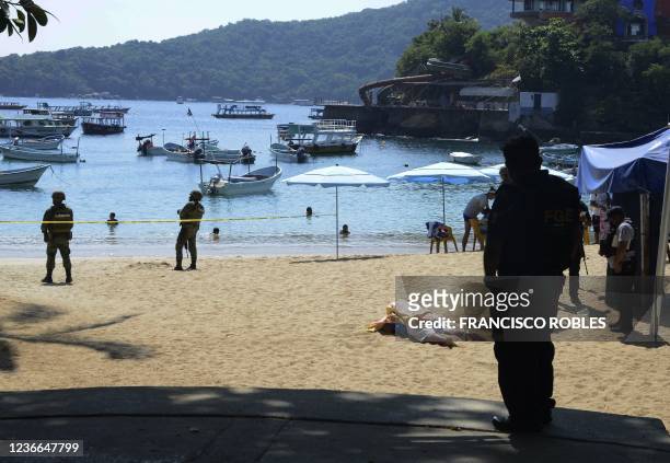 The body of a tourist service provider who was murdered lies at the Caleta and Caletilla beach in Acapulco, Mexico, on November 18, 2021.