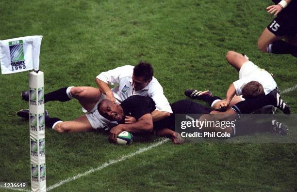 Jonah Lomu of New Zealand touches down in the corner to score a try against against England during the Rugby World Cup Pool B game at Twickenham in...