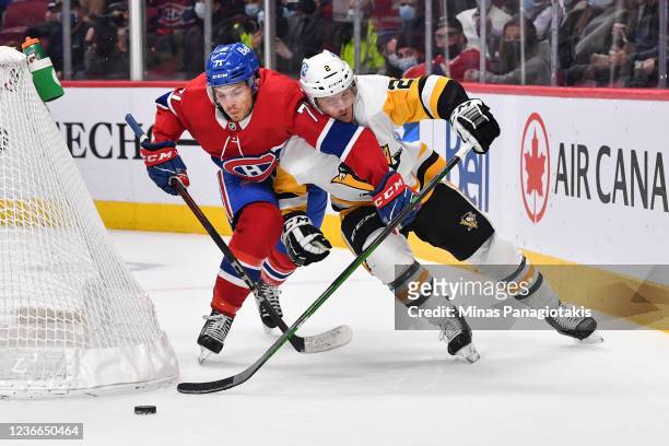 Jake Evans of the Montreal Canadiens and Chad Ruhwedel of the Pittsburgh Penguins skate after the puck during the first period at Centre Bell on...