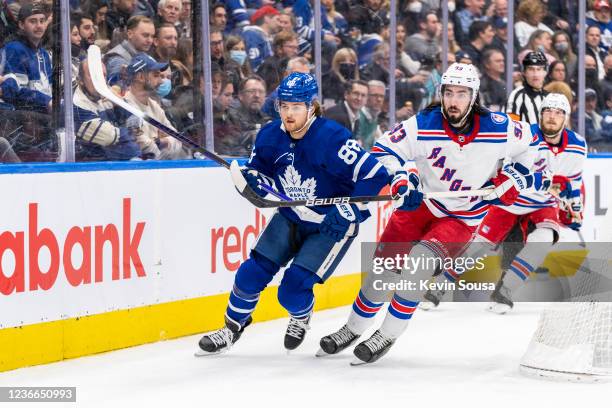 William Nylander of the Toronto Maple Leafs battles against Mika Zibanejad of the New York Rangers during the second period at the Scotiabank Arena...