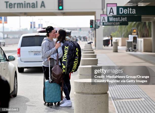 Santa Ana, CA Jordan McArthur kisses his girlfriend, Hailey Murphy, before she heads home to Canada for the Thanksgiving break at John Wayne Airport...