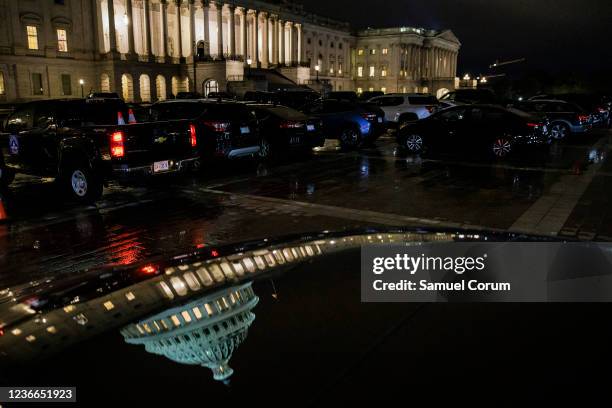 Vehicles of representatives fill the East Front of the U.S. Capitol Building as Democrats attempt to hold a vote on the Build Back Better legislation...