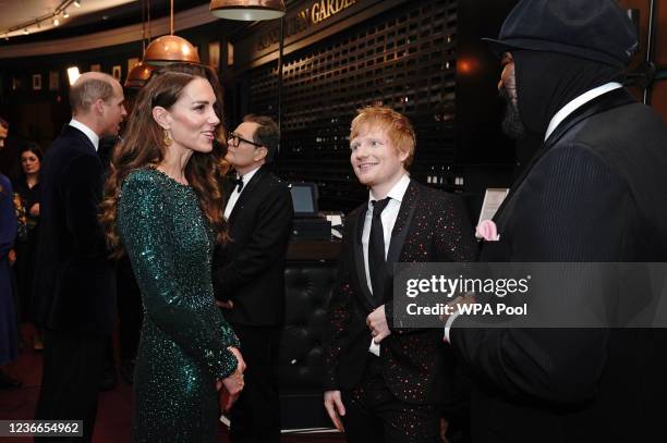 Prince William, Duke of Cambridge speaks to comedian Alan Carr as Catherine, Duchess of Cambridge speaks to singers Ed Sheeran and Gregory Porter...