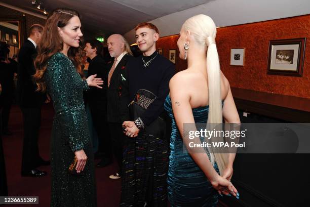 Catherine, Duchess of Cambridge speaks to singers Olly Alexander and Anne-Marie after watching the Royal Variety Performance at Royal Albert Hall on...