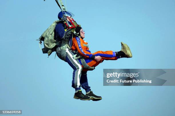 Contestants make a tandem jump during the parachuting competition at the Odesa Flying Club, Odesa, southern Ukraine.