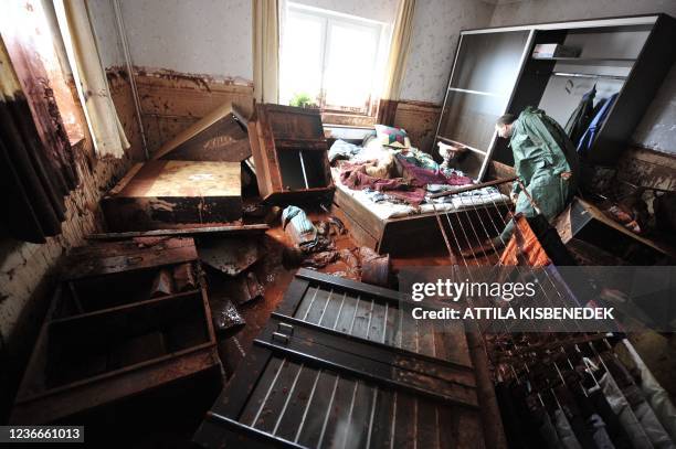 Year old resident checks his new furniture in Kolontar about 160 kms southwest of Budapest, on October 6, 2010 after a wave of toxic red mud swept...