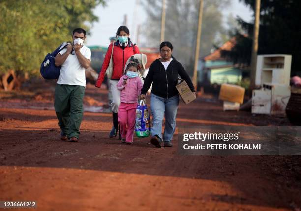 Gipsy family walk on a red-mud covered street in the flooded town of Devecser, 150 km west of Hungarian capital Budapest on October 8, 2010. Wave of...