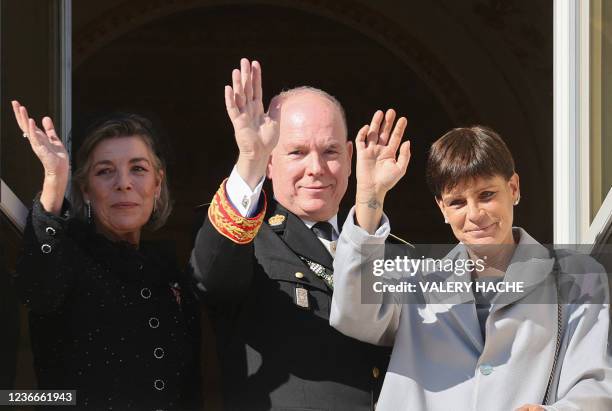 Prince Albert II of Monaco , Princess Caroline of Hanover and Princess Stephanie of Monaco waves from the balcony of Monaco Palace during the...