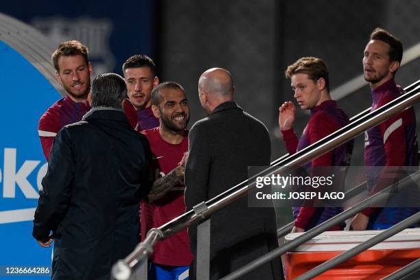 Barcelona's Brazilian defender Dani Alves is greeted by FC Barcelona's Spanish sporting advisor Jordi Cruyff as he arrives for a training session in...