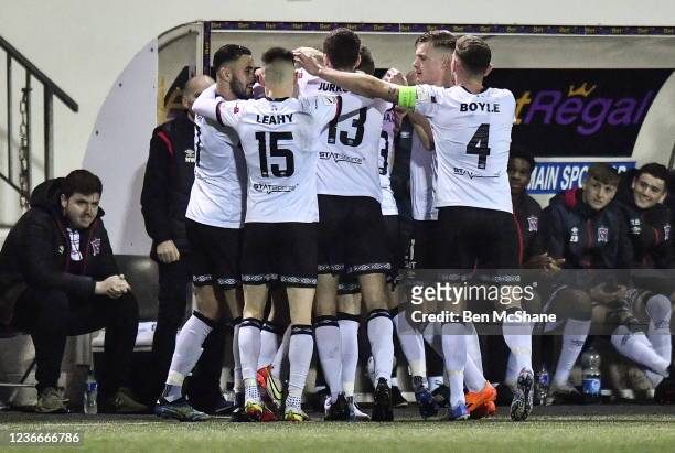 Louth , Ireland - 19 November 2021; Dundalk players celebrate with Dundalk head coach Vinny Perth, hidden, after their first goal during the SSE...