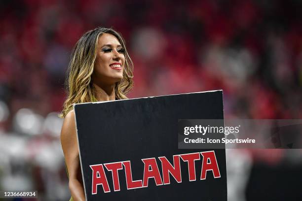 An Atlanta cheerleader with a sign during the NFL game between the New England Patriots and the Atlanta Falcons on November 18th, 2021 at...