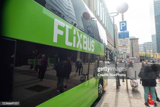 Green bus of FlixBus with the inscription and the brand logo on the side of the vehicle, as seen in the streets of Brussels near the Gare Du Nord,...