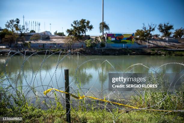 Razor wire lines the area near the Rio Grande river on November 19, 2021 in Eagle Pass, Texas. - Texas Governor Greg Abbott made a post on his...