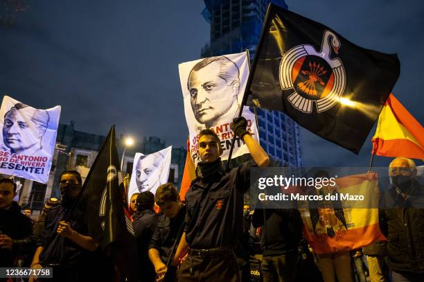 Far right wing members and supporters of La Falange carrying banners and pre-constitutional flags during a demonstration marking the 85th anniversary...