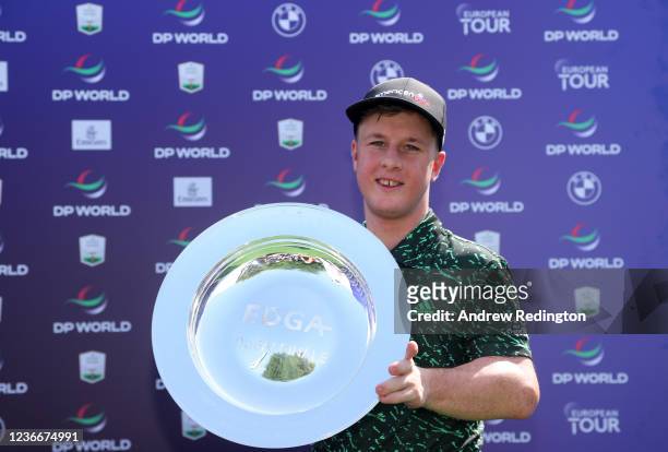 Brendan Lawlor of Ireland poses with the trophy after winning the Edga Dubai Final, part of The DP World Tour Championship at Jumeirah Golf Estates...