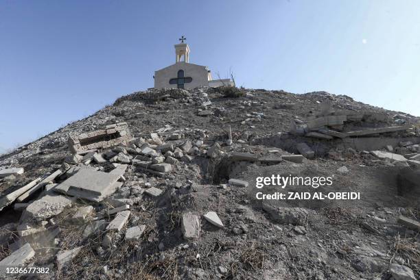 This picture taken on November 19, 2021 shows a view of the rubble of broken tombstones, damaged by Islamic State group fighters during their...