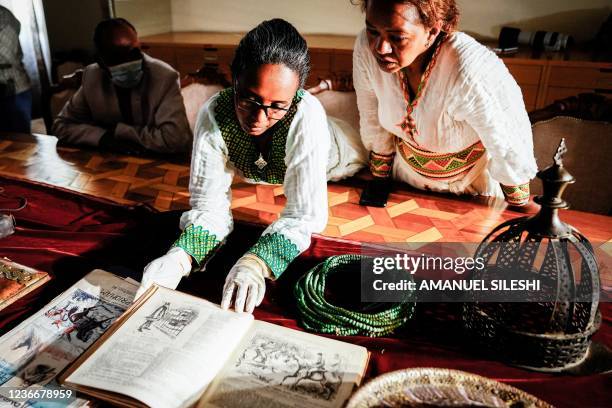 Staff look at recovered items to be on display at the National Museum as Ethiopia hailed the return of precious artefacts looted by British soldiers...