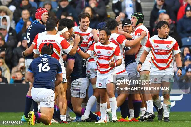 Japan players celebrate their try during the Autumn International friendly rugby union match between Scotland and Japan at Murrayfield Stadium in...