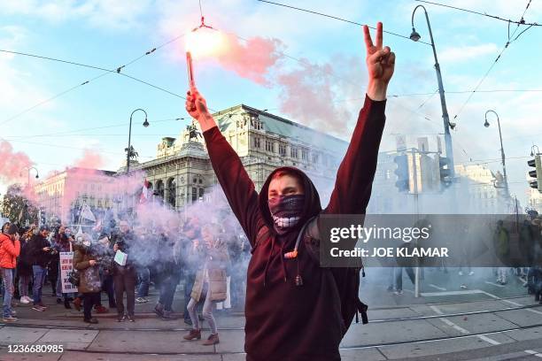 Demonstrators light flares during a rally held by Austria's far-right Freedom Party FPOe against the measures taken to curb the coronavirus pandemic,...