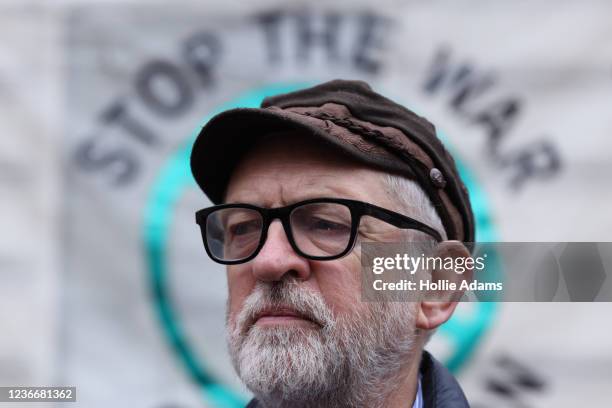 Former Labour Party leader Jeremy Corbyn stands in front of a Stop the War Coalition banner during a Stand Up To Racism protest outside the Embassy...