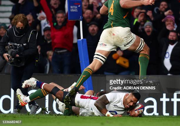 England's centre Manu Tuilagi scores his team's first try during the Autumn International friendly rugby union match between England and South Africa...