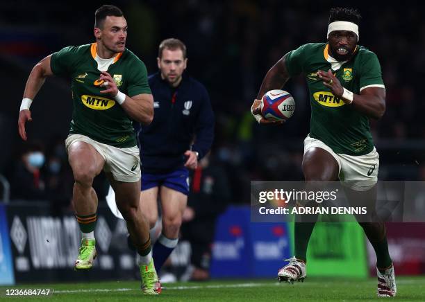 South Africa's wing Jesse Kriel runs alongside South Africa's flanker Siya Kolisi during the Autumn International friendly rugby union match between...